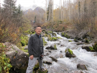 Guoqing Ge near mountain stream
