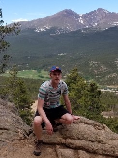 Mariusz Starzec enjoying a trail with a backdrop of Mount Meeker and Longs Peak.