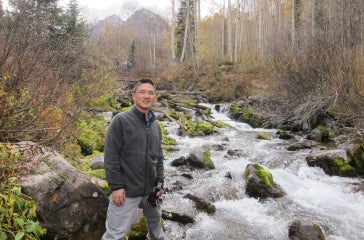 Guoqing Ge near mountain stream